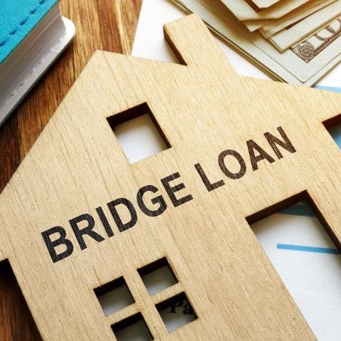 move forward with confidence Wooden house silhouette with "BRIDGE LOAN" text and scattered currency notes.